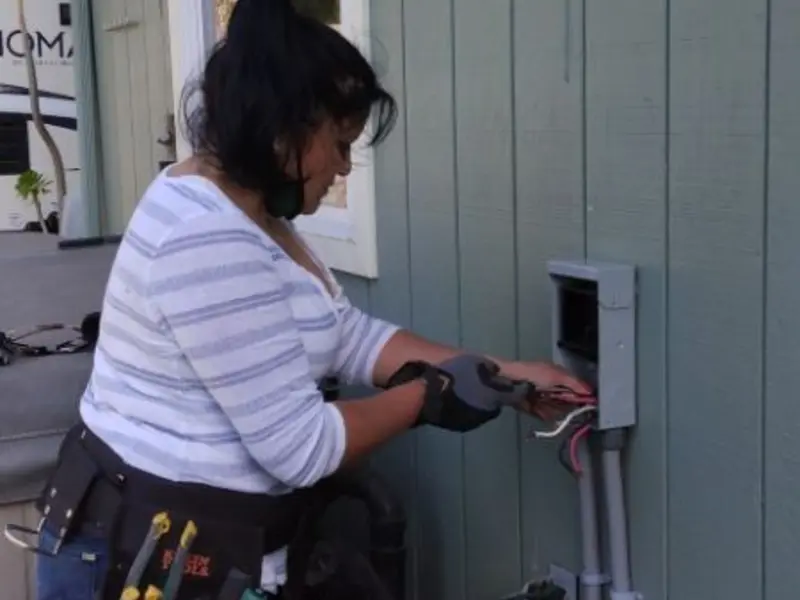 Licensed electrician wiring an exterior subpanel in Riverside